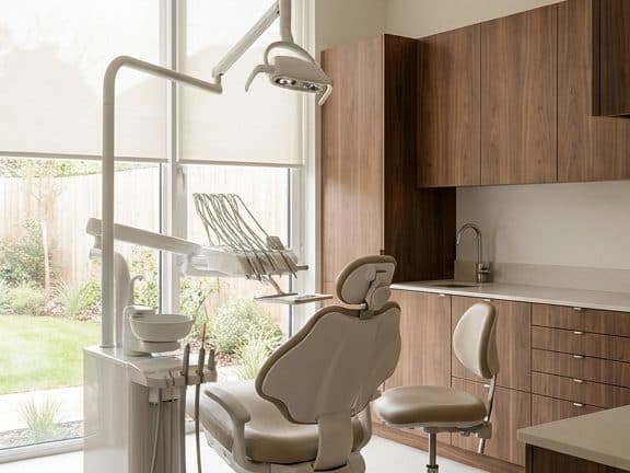 Serene modern dental treatment room with warm wood