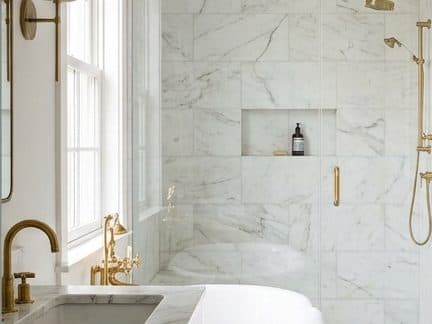 Finished luxury bathroom with brass fixtures and marble